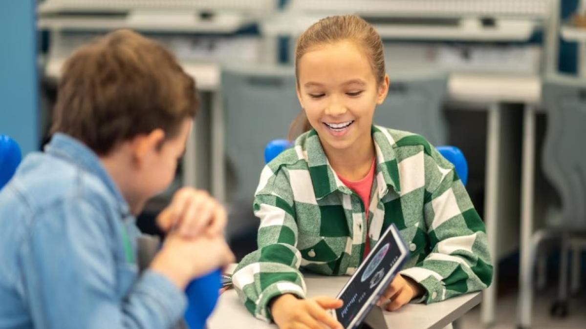 Two students are working at desks