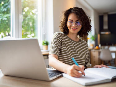 Smiling women working at a computer