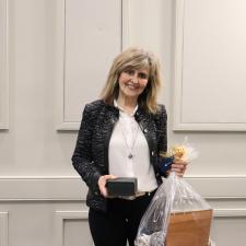 Employee holds gift celebrating her long term service